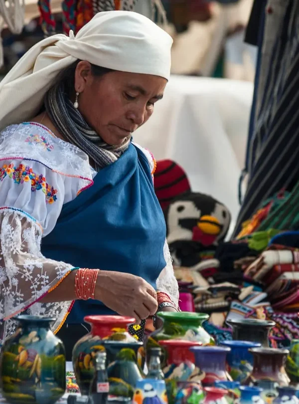 Colorful textile market in Otavalo, surrounded by mountains and local culture.