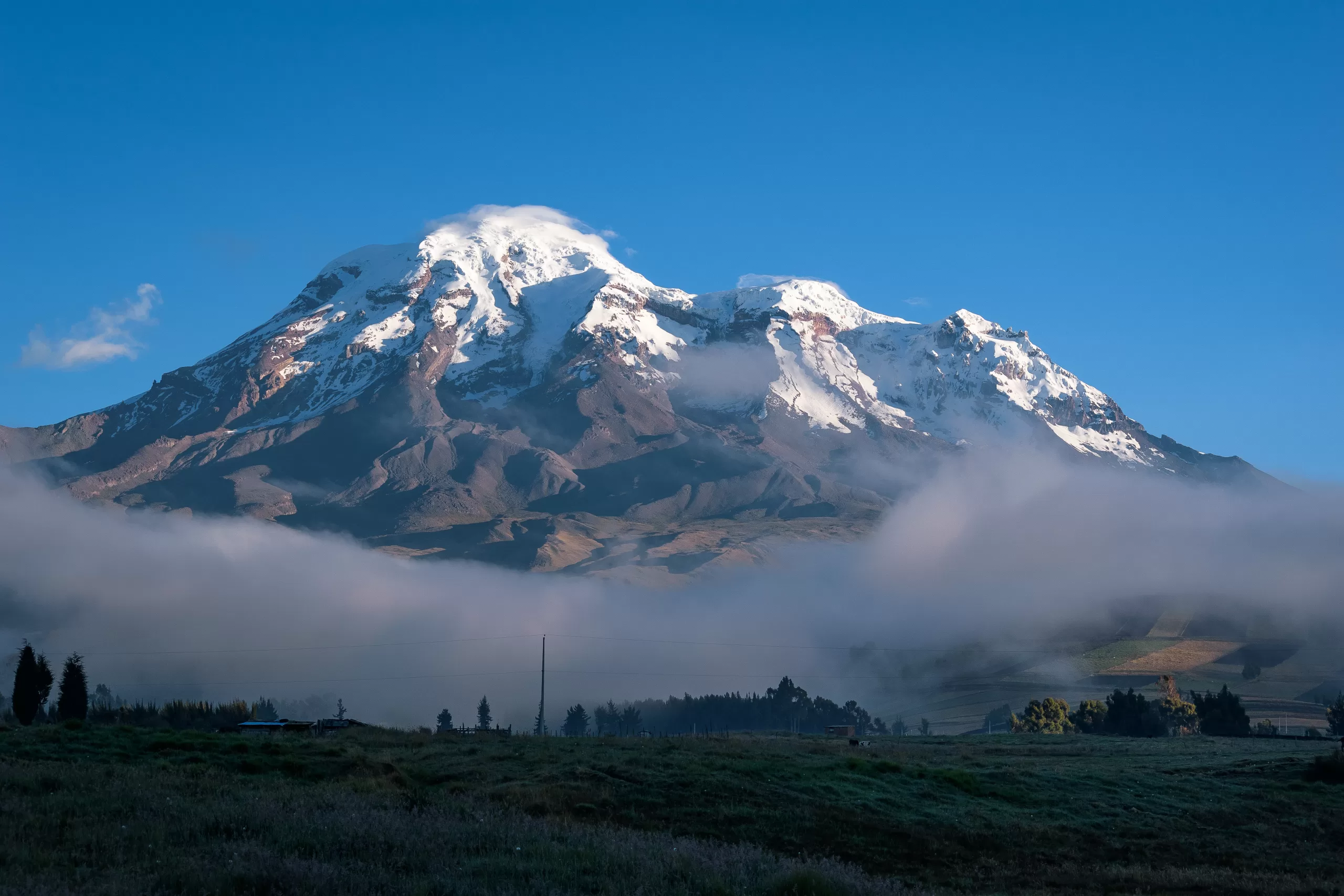 Snow-capped Chimborazo Volcano rising above the Andean highlands in Ecuador.