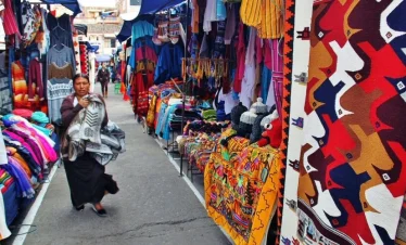 Panoramic view of Otavalo town with mountains in the background during a private tour
